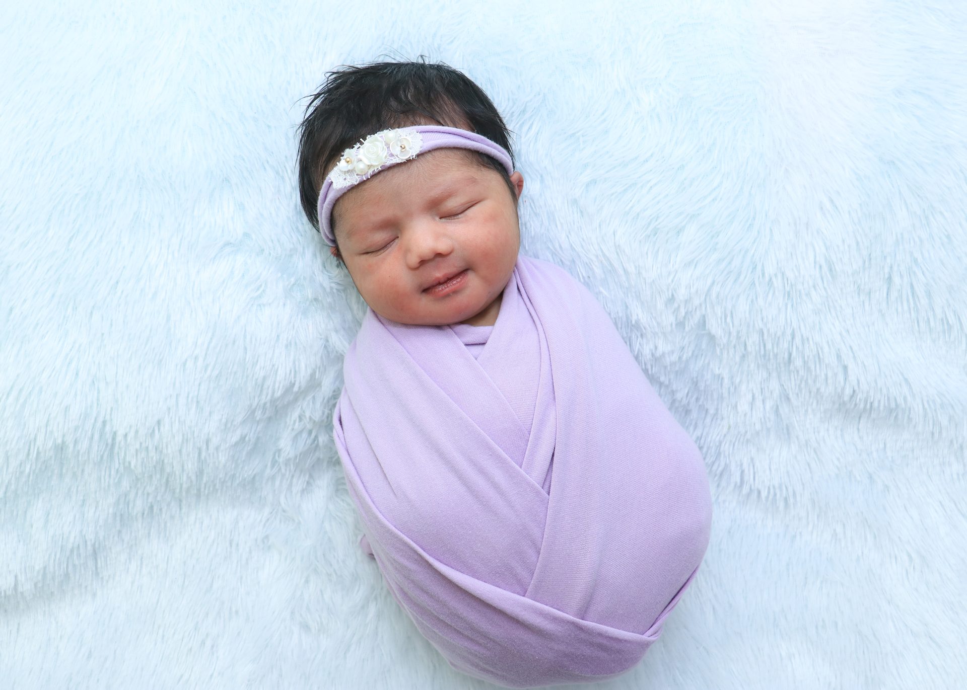 Newborn - lavender wrap smiling
